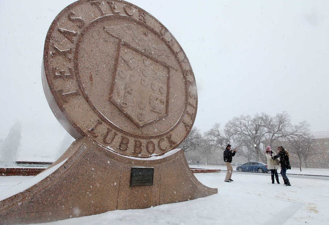 Liv Sev, left, Alice Paulino, center, and Pollyne Almeida, right, play in the snow on the campus of Texas Tech on Sunday. A winter weather system brought snowfall and ice to a large portion of West Texas.