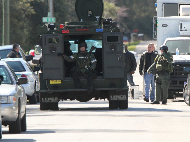 The Marion County Sheriff's Office SWAT team uses an armored vehicle during a standoff in Ocala Estates on Sunday morning.