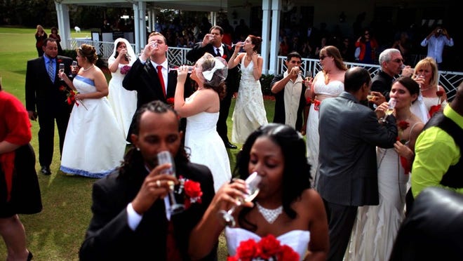 Couples enjoy the champagne toast after the ceremony on Tuesday.