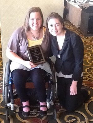 Becky Taylor, left, poses with Theresa Squires, after earning a Young Leader Award winners, selected by the Michigan Developmental Disabilities Council.