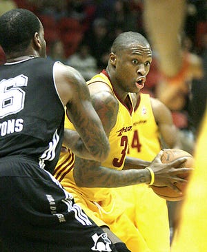 Canton Charge's Frank Hassell makes his move to the basket on Austin Toros's Leo Lyons.