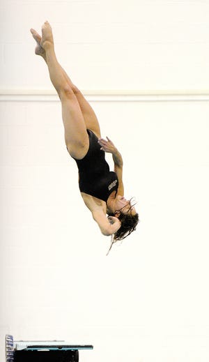 Jackson diver Josie McKee performs Feb. 8 in diving sectional. McKee won the event, which also qualified her for the district taking place this week at Cleveland State University.