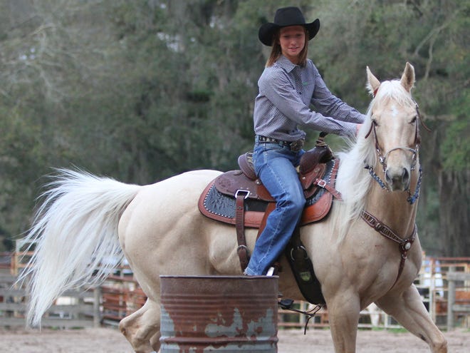 Dakota Randolph takes her horse, 20X, around a barrel at Stormy Gray Farm in Citra. The Florida High School Rodeo takes place Friday and Saturday at the Southern Livestock Pavillion.