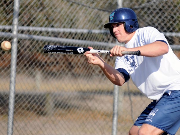 UNCW baseball player Andrew Cain bunts during drills at practice at Brooks Field on February 15, 2012.