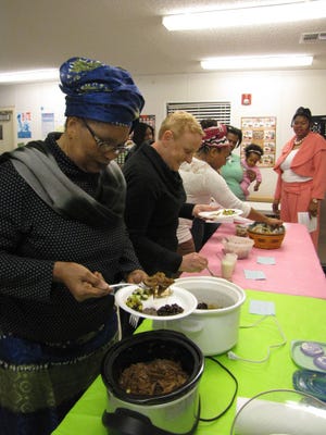 Participants in the “Fill the Plate, Fill the Mind” workshop sample foods featured in the healthy food demonstration.
