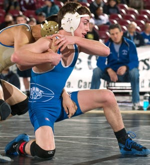 Central's Jeremy Baca werestles Broomfield's Drew Romero during
the Class 4A Region 3 106-pound championship match Feb. 11. 2012 at
the State Fair Events Center. Photo by Mike Sweeney