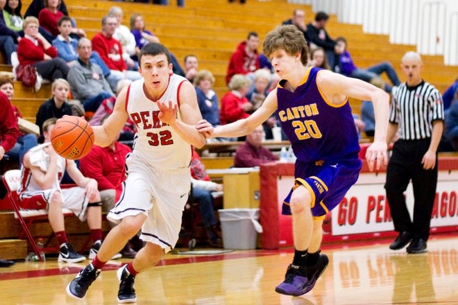 Pekin's Trey Scotti charges towards the hoop while Canton's Levi Draughan defends during their game Friday.
Skyler Edwards / Times staff