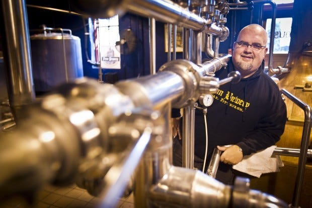 Andy Rich, brewmaster at Penn Brewery, poses fin front of the
tanks they use to brew beer. Rich is chairman of the group that is
planning the first-ever Pittsburgh Craft Beer Week, to be held
April 20-28.