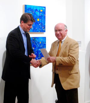 Doug Walvoord receives a mini-grant for the Chamber Music Festival of Saugatuck from State Rep. Joe Haveman at the Holland Area Arts Council on Feb. 16, 2012.