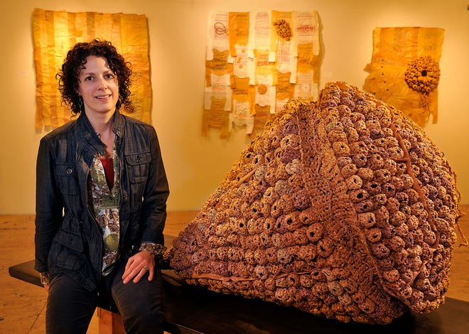 Artist Michelle Lougee of Cambridge pictured with "Dinoflagellate," made with more than 500 crocheted plastic bags, on exhibit at the Fountain Street Fine Arts in Framingham.
Daily News photo by Art Illman