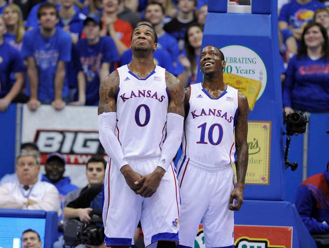 Thomas Robinson, left, and Tyshawn Taylor watch a video Saturday highlighting some of Robinson's dunks during Kansas' victory against Texas Tech. Jayhawks coach Bill Self noticed and says he worries his team may be losing focus.
