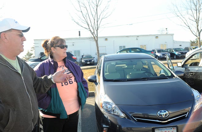 Kevin and Ann Hoarty of Rockland talk about the Prius they bought at Route 44 Toyota in Raynham on Sunday.