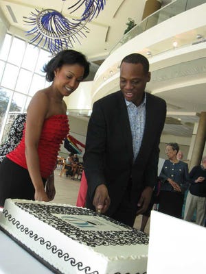 Timothy.Gibbons@jacksonville.com Terrance Patterson, founder of the Ritz Chamber Players, and Kelly Hall-Tompkins, a violinist, cut the birthday cake during a celebration Sunday.