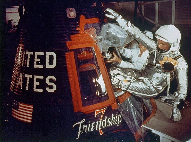 Astronaut John Glenn climbs into his Friendship 7 Mercury capsule atop an Atlas rocket on Feb. 20, 1962, at Cape Canaveral, Fla. for the flight that made him the first American to orbit the Earth.