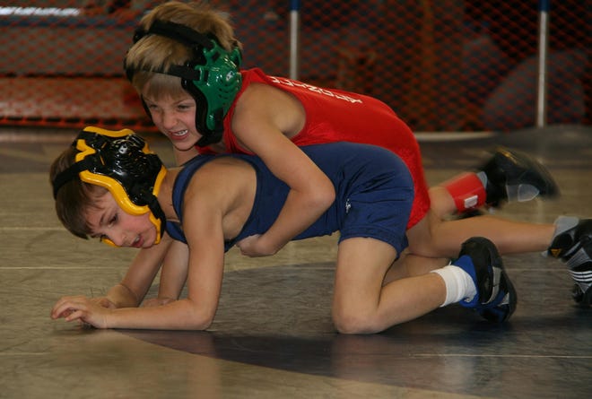 Killingly Youth Wrestling’s Hayden Ferland, top, wrestles Newtown Youth Wrestling’s Daniel Accomando at the Mighty Mite and Bantam State Championships on Feb. 12 at Bristol Eastern High School.