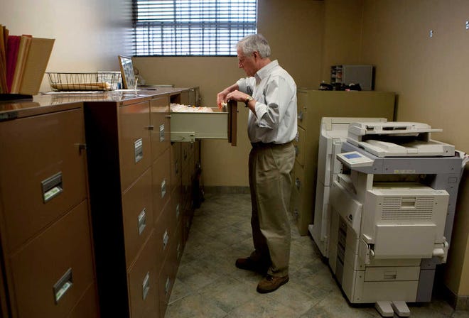 Steve Wyard, 61, a regional sales director of All Valley Washer Service, looks for files in his office in the Van Nuys section of Los Angeles. Wyard and his wife have two sons, 19 and 21, to put through college, and they see that pushing back retirement for several years. Until then Wyard plans to keep working.