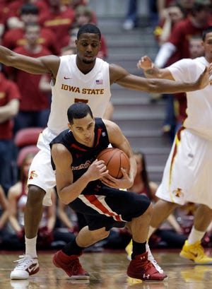 Texas Tech guard Ty Nurse falls to the court in front of Iowa State forward Melvin Ejim, rear, during the first half of Wednesday's game in Ames, Iowa.