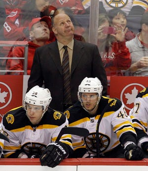 Bruins head coach Claude Julien checks the scoreboard during a win over the Capitals on Feb. 5. Juloien and the B's are in St. Louis to face the Blues tonight.