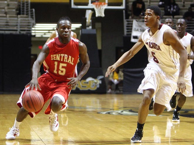 Central's Terrance Rice dribbles down the court alongside Sylacauga's Donterious Riggins in the first round of the boys Class 5A AHSAA Central Regional at the Dunn-Oliver Acadome in Montgomery Wednesday.