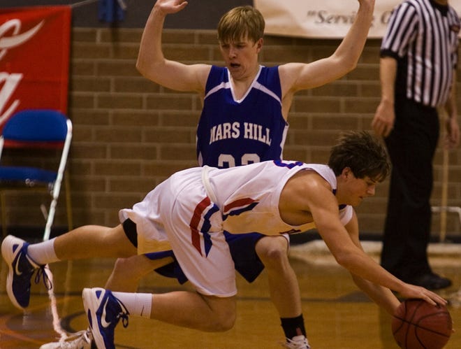 American Christian Academy’s Collin Crowe draws a foul diving for a loose ball Wednesday against Mars Hill.