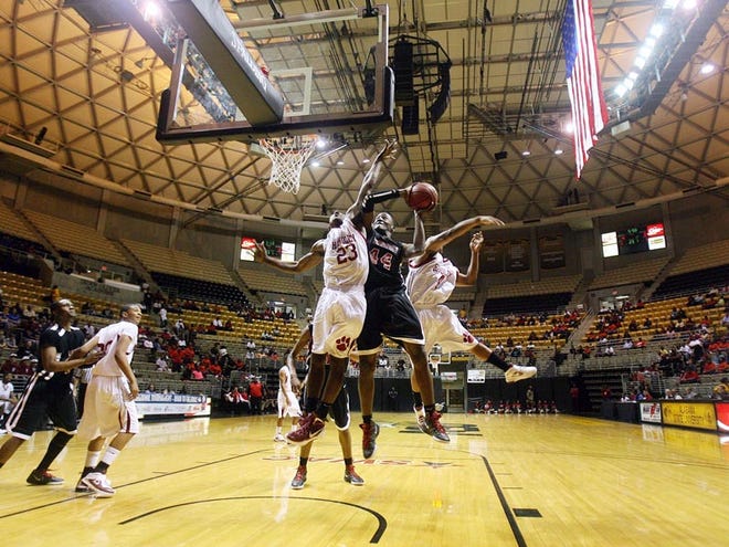 Handley's Tevin Cook and Artravian Kyles jump to block Greensboro's Kavoris Owens in the first round of the boys Class 3A AHSAA Central Regional tournament at the Dunn-Oliver Acadome in Montgomery Thursday