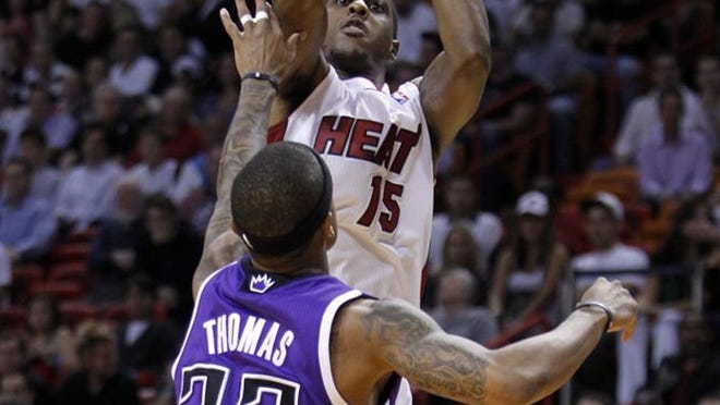 Mario Chalmers launches a shot over Isaiah Thomas in the Heat's victory Tuesday, Feb. 21, 2012. Chalmers finished with 20 points, including six three-pointers.