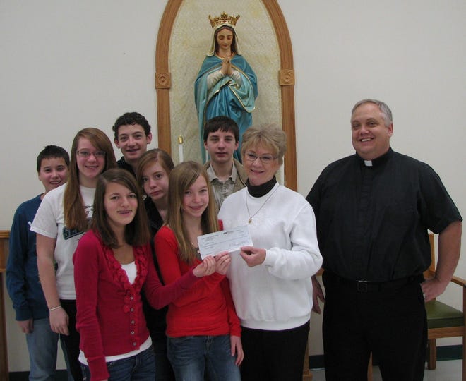 Confirmation class donates to food pantry
Pictured (left to right) are St. Mary’s Confirmation students Sean Lucas, Heather Cox, Kerrie Elson, Bradley Henseler, Hannah Cox, Nicole Beebe, and Jacob Longenecker (not present, Ashten Batterton) presenting a check to Joyce Batterton, St. Mary’s Food Pantry volunteer. At right is the Pastor of St. Mary’s Church, Reverend Daniel Ebker.