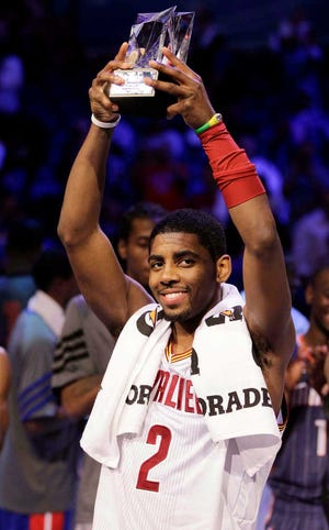 Cleveland Cavaliers' Kyrie Irving, of Team Chuck, holds the MVP trophy following the NBA All-Star Rising Stars Challenge game in Orlando, Fla., on Friday. Team Chuck defeated Team Shaq, 146-133.