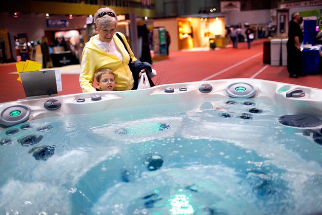 Finley Hennken, 5, and his grandmother Mariley Hennken take a look at a Jacuzzi hot tub during the 2012 Mid-Missouri Home & Lifestyle Expo in Columbia Saturday. The expo featured a variety of booths for both adults and children, showcasing a variety of home improvement products.