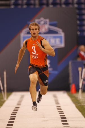 Michigan State quarterback Kirk Cousins runs a drill at the NFL football scouting combine in Indianapolis on Saturday, Feb. 25, 2012.