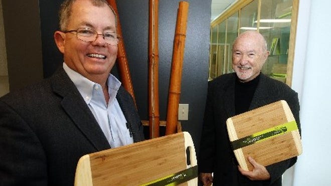 President Kevin Mahoney (left) and Executive Vice President Dan Demicell of TruBamboo pose for a portrait holding some of their cutting boards at their offices in Boynton Beach.
