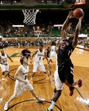 Texas Tech's Jordan Tolbert (32) goes up for a dunk attempt past Baylor's Quincy Acy, right rear, and Brady Heslip (5) during their game Monday in Waco. Baylor won, 77-48.