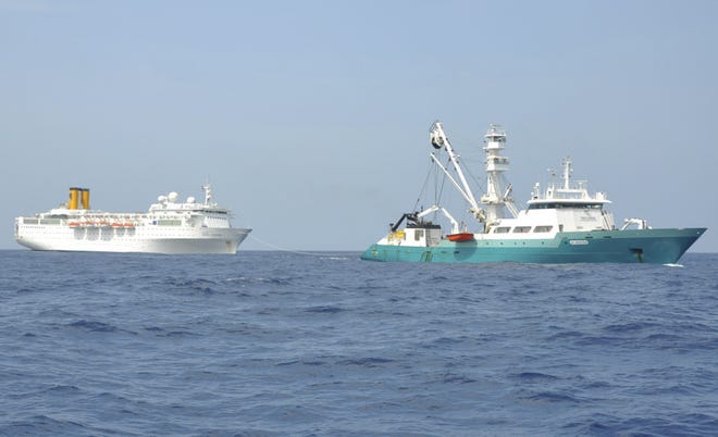 In this photo taken by a member of French fishing vessel, The Talenduic, and provided by the Prefecture of the Reunion Island, shows the Italian cruise ship, The Costa Allegra, left, being towed by French fishing vessel, The Trevignon, in the Indian Ocean, Tuesday, Feb. 28, 2012. The French fishing vessel The Trevignon on Tuesday began towing an Italian cruise ship drifting powerless in the Indian Ocean to a nearby Seychelles island, but was not expected to reach the tiny resort island until Wednesday, officials said. Seychelles authorities said they are making arrangements to evacuate people to the island of Desroches and then to transfer the more than 1,000 passengers and crew members to the main Seychelles island of Mahe by plane and fast boats.