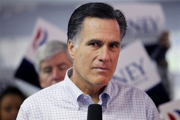 Republican presidential candidate, former Massachusetts Gov. Mitt Romney, listens to a question from a reporter as he visits a campaign call center in Livonia, Mich., Tuesday, Feb. 28. Michigan Gov. Rick Snyder is at left. (AP Photo/Gerald Herbert)