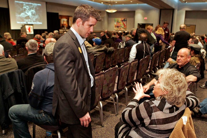 Congressional candidate Adam Kinzinger (left) talks to Linda Urbelis and Richard Fun, both of Rockford, Wednesday, Feb. 22, 2012, during a town hall meeting hosted by IllinoisCarry.com at Giovanni's in Rockford.