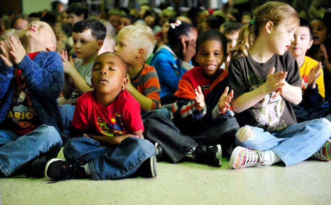 Kindergartener Jacob Adams (second from left) nods off during a jazz performance in the cafeteria at McBean Elementary School in Hephzibah.