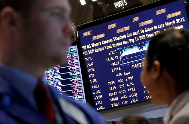 A board on the floor of the New York Stock Exchange on Tuesday shows the closing number for the Dow Jones Industrial average. The Dow closed above 13,000, the first time since May 2008, four months before the financial crisis began.