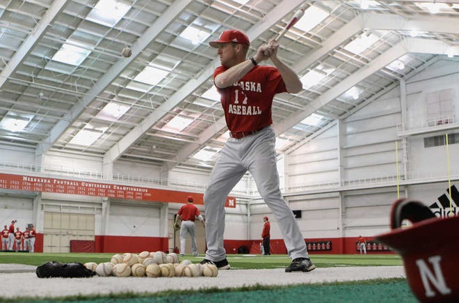 In this photo taken, Tuesday, Feb. 28, 2012, Nebraska coach Darin Erstad drills his outfielders during indoor NCAA college baseball practice to avoid bad weather in Omaha, Neb. Minnesota's John Anderson, the winningest coach in Big Ten history, is pushing the possibility of his conference and other northern leagues breaking away from the NCAA's traditional February-to-June schedule and playing when the weather is more favorable. In short, putting the boys of summer on the field during summer. (AP Photo/Nati Harnik)