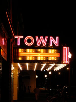 A side view of the Town Theatre marquee lit at night