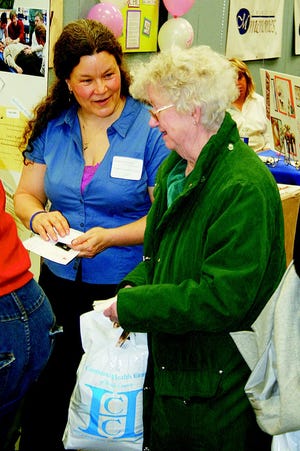 Laurie Rowe, left, of Integrative Somatics talks with an attendee at a previous Women’s Health Fest event.