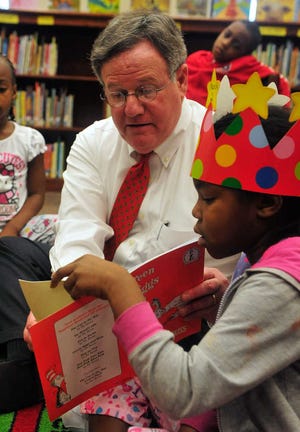 Richard Hamm/Staff Doc Eldridge, President of the Athens Area Chamber of Commerce, reads a Dr. Seuss book to students at Chase Street Elementary School during Read Across America day on Friday, March 2, 2012 in Athens, Ga.