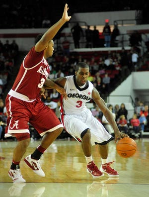 Georgia's Dustin Ware dribbles past Alabama's Trevor Lacey during the Saturday, Jaunary 7, 2012 men's basketball game between the Georgia Bulldogs and the Alabama Crimson Tide at Stegeman Coliseum in Athens, Ga. (AJ Reynolds/Staff andrew.reynolds@onlineathens.com)