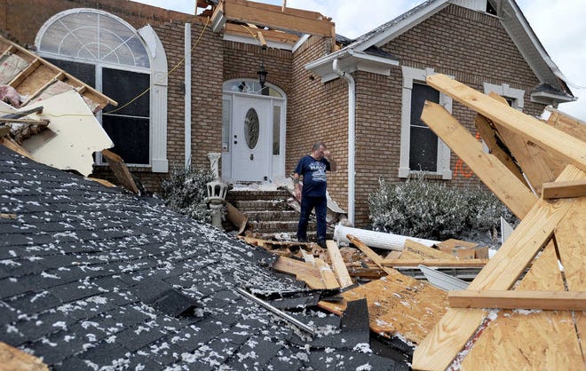 Charles Kellogg walks away from his destroyed house after severe weather hit the Eagle Point subdivision in Limestone County, Ala. on Friday, March 2, 2012. A reported tornado destroyed several houses in northern Alabama as storms threatened more twisters across the region Friday (AP Photo/The Decatur Daily, Jeronimo Nisa)