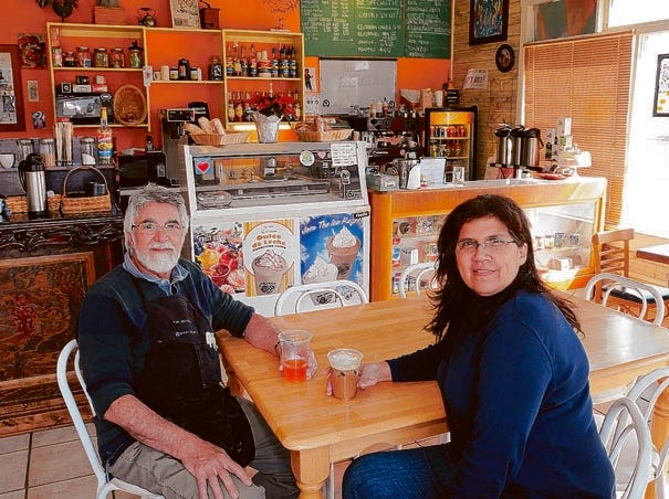 Folks Cafe owners Juan and Tammy Pacina take a break from serving coffee at the cafe Monday, Feb. 21.