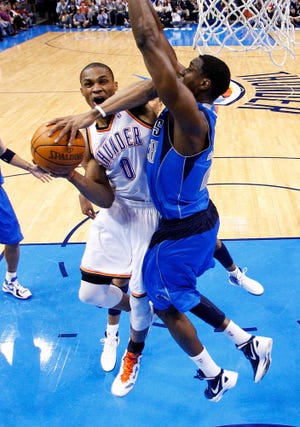 Oklahoma City guard Russell Westbrook (left) shoots as Dallas' Ian Mahinmi defends during Monday's game.