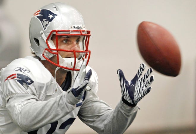 New England Patriots wide receiver Wes Welker (83) keeps his eyes on the ball on a catch during NFL football practice in Foxborough, Mass., Wednesday Dec. 7, 2011. (AP Photo/Charles Krupa)