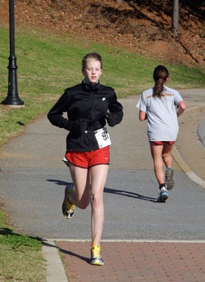 Amy Gayer, 12, competes in the Early Bird Sprint Triathlon on Sunday.