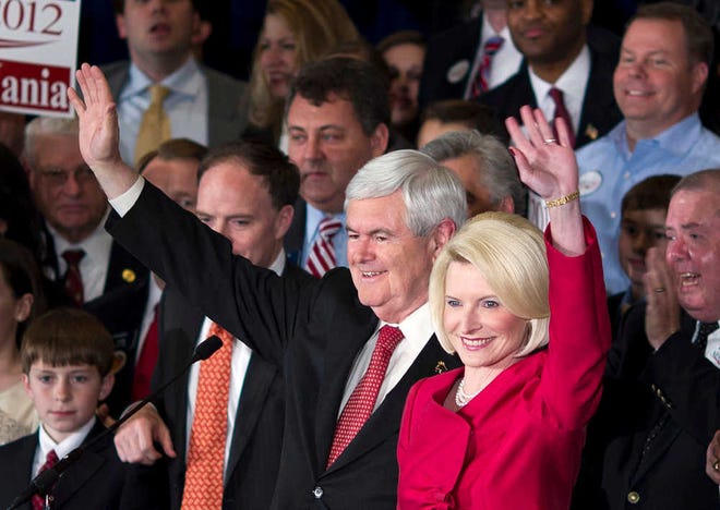 Republican presidential candidate, former House Speaker Newt Gingrich, left, and his wife Callista wave as they arrive for a Super Tuesday rally on Tuesday, March 6, 2012 in Atlanta. (AP Photo/Evan Vucci)