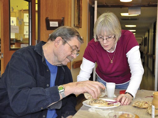 Larry Ahrends of ASTA Care Center, received a helping hand from activities director Kathy Finkenbinder Saturday, as they made bird feeder treats.