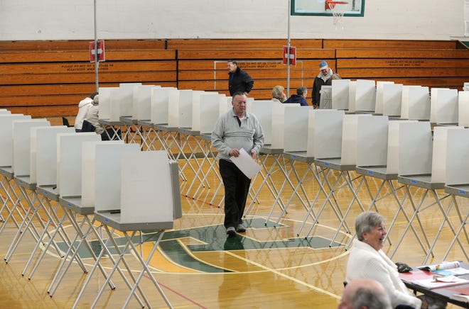 John Foley of Abington, center, is one of the few voters at Abington High School on Tuesday, March 6, 2012.